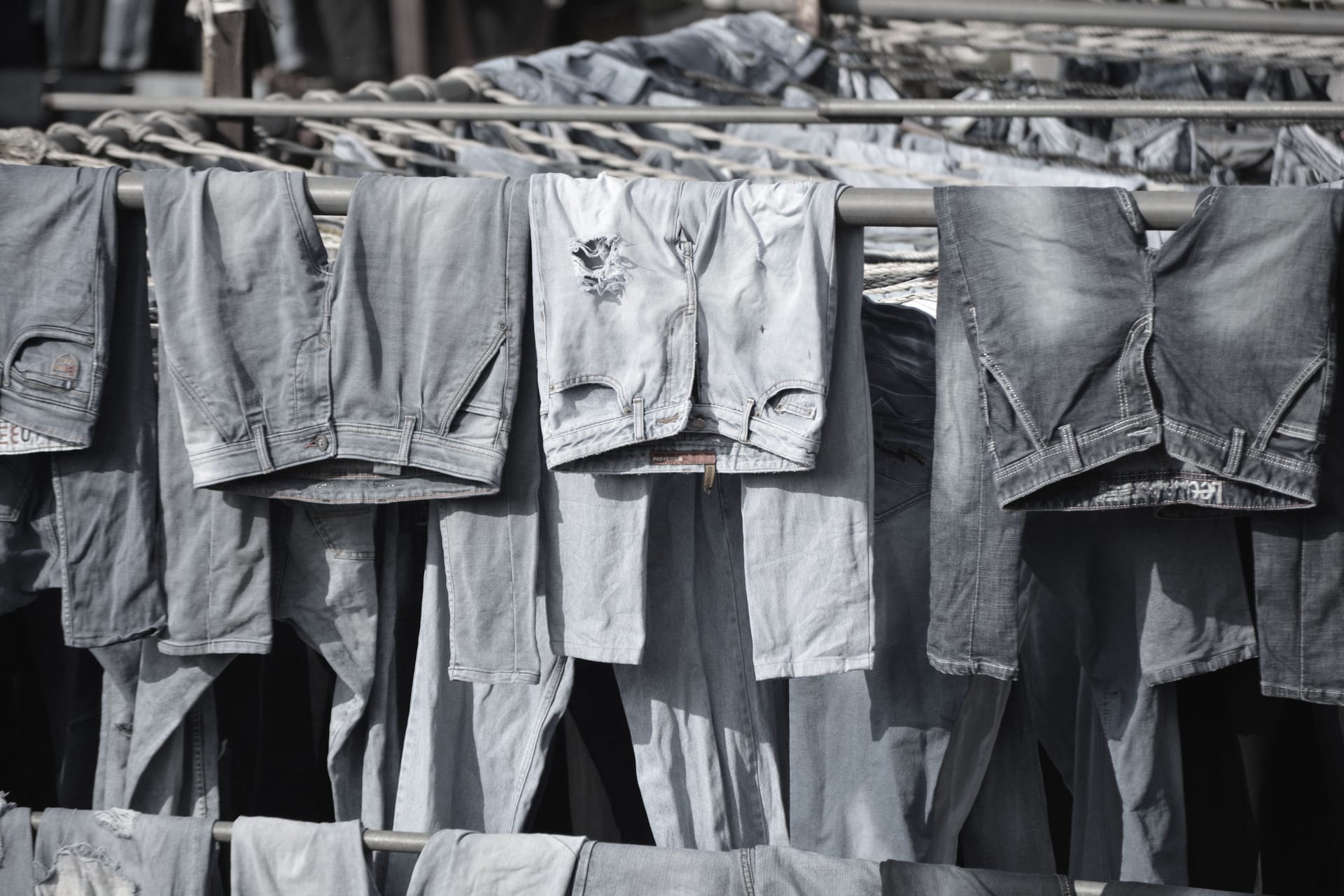 Light-wash jeans hanging to dry on the finishing line in Xintang